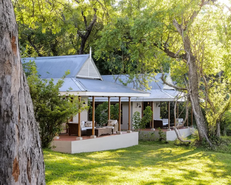 Luxury safari suite at Baines River Camp surrounded by riverside forest in Zambia